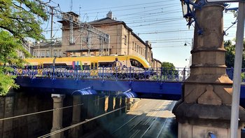 Pociąg przejeżdża po wiadukcie kolejowym nad ul. Lubicz, fot. Piotr Hamarnik