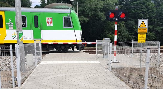 Pociąg jedzie przez przejazd prowadzący do Rezerwatu Olszynka Grochowska, fot. K. Mazurek
